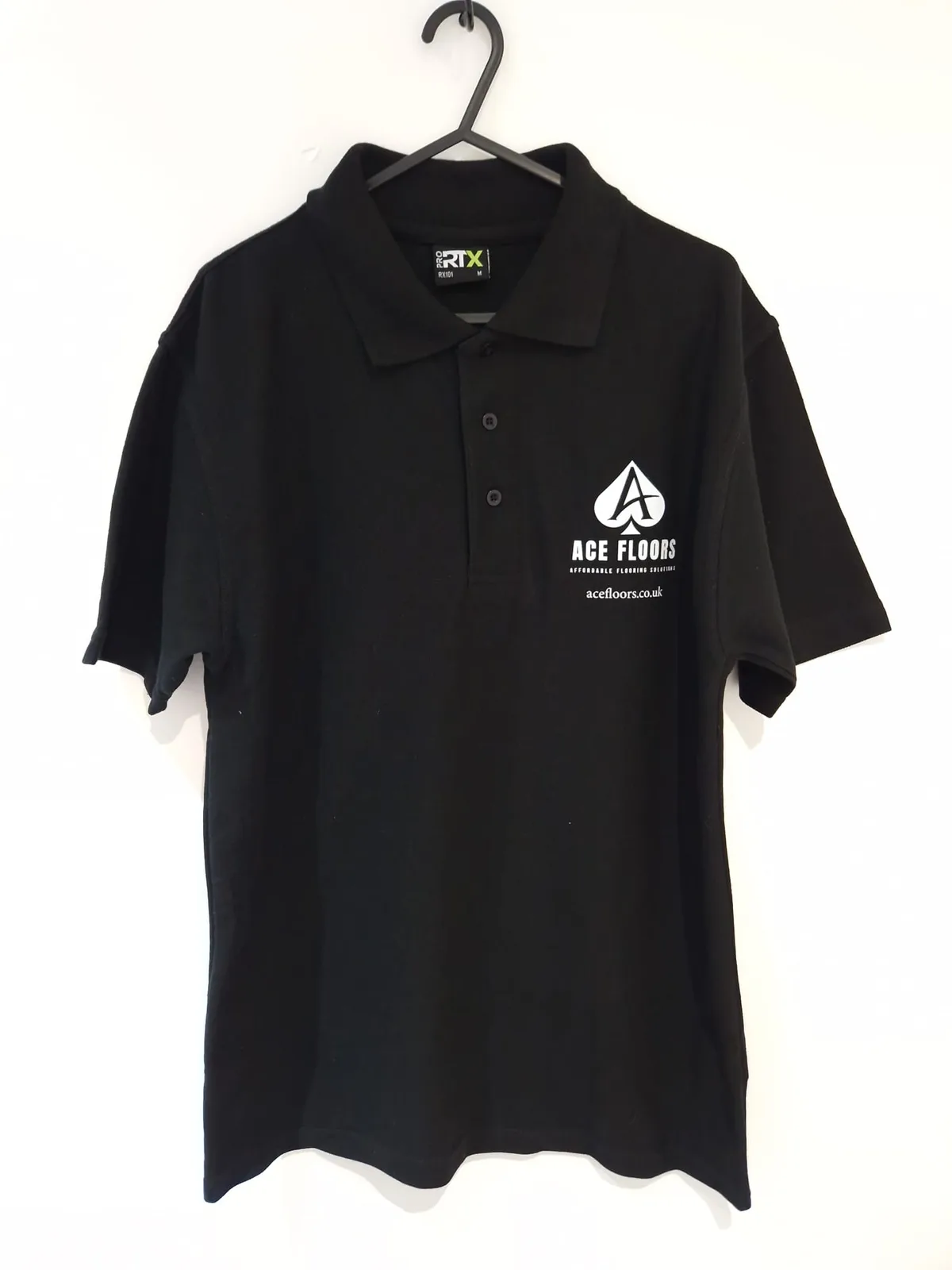 Black polo shirt with Ace Floors chest branding