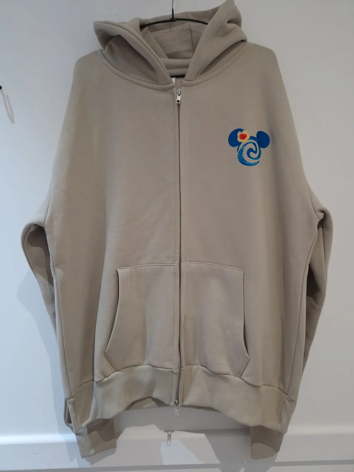 Beige zip hoodie with colourful chest graphic