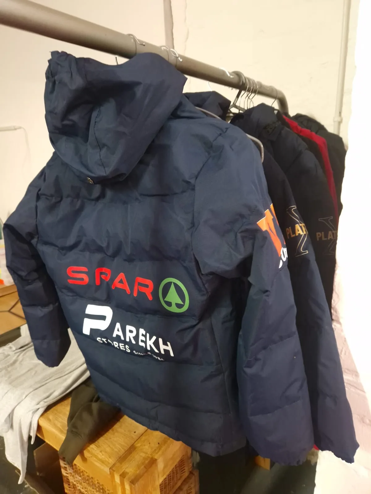Navy padded sports jacket with SPAR and Parkh sponsor logos