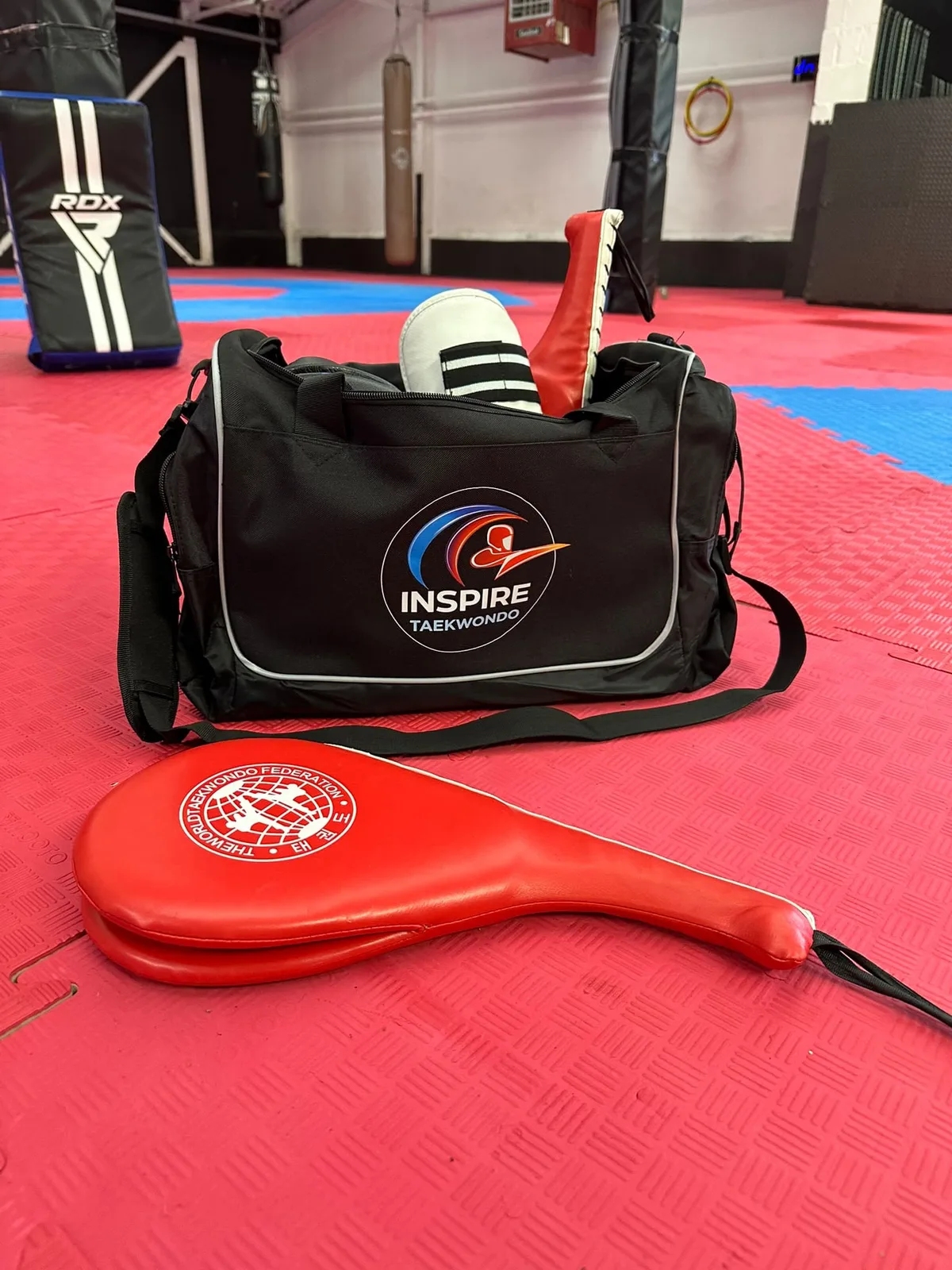 Inspire Taekwondo branded kit bag on training mats