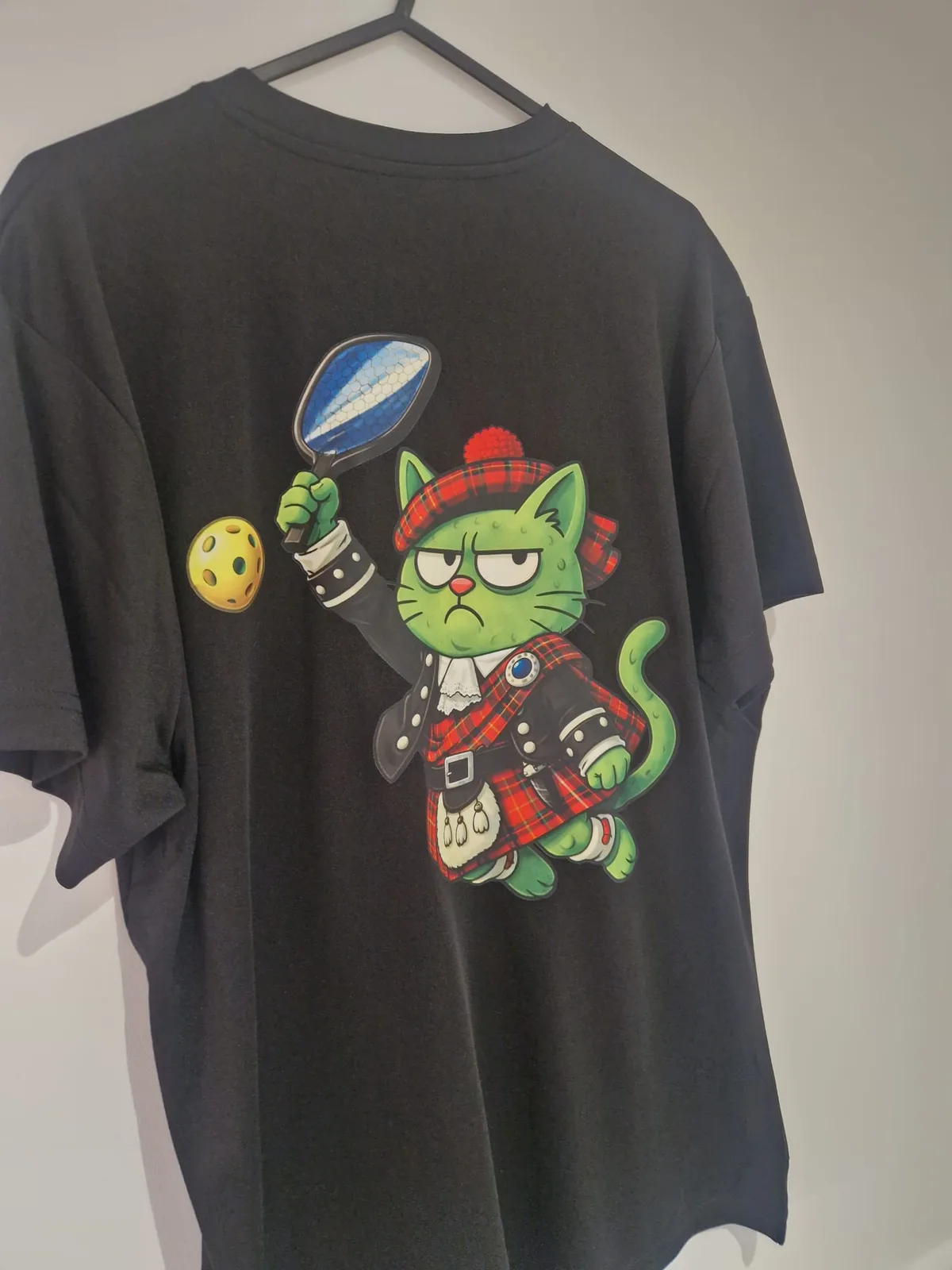 Black Picklepuss t-shirt with colourful pickleball character back print