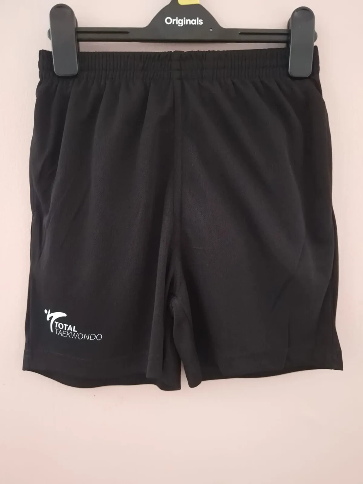 Black training shorts with Total Taekwondo logo